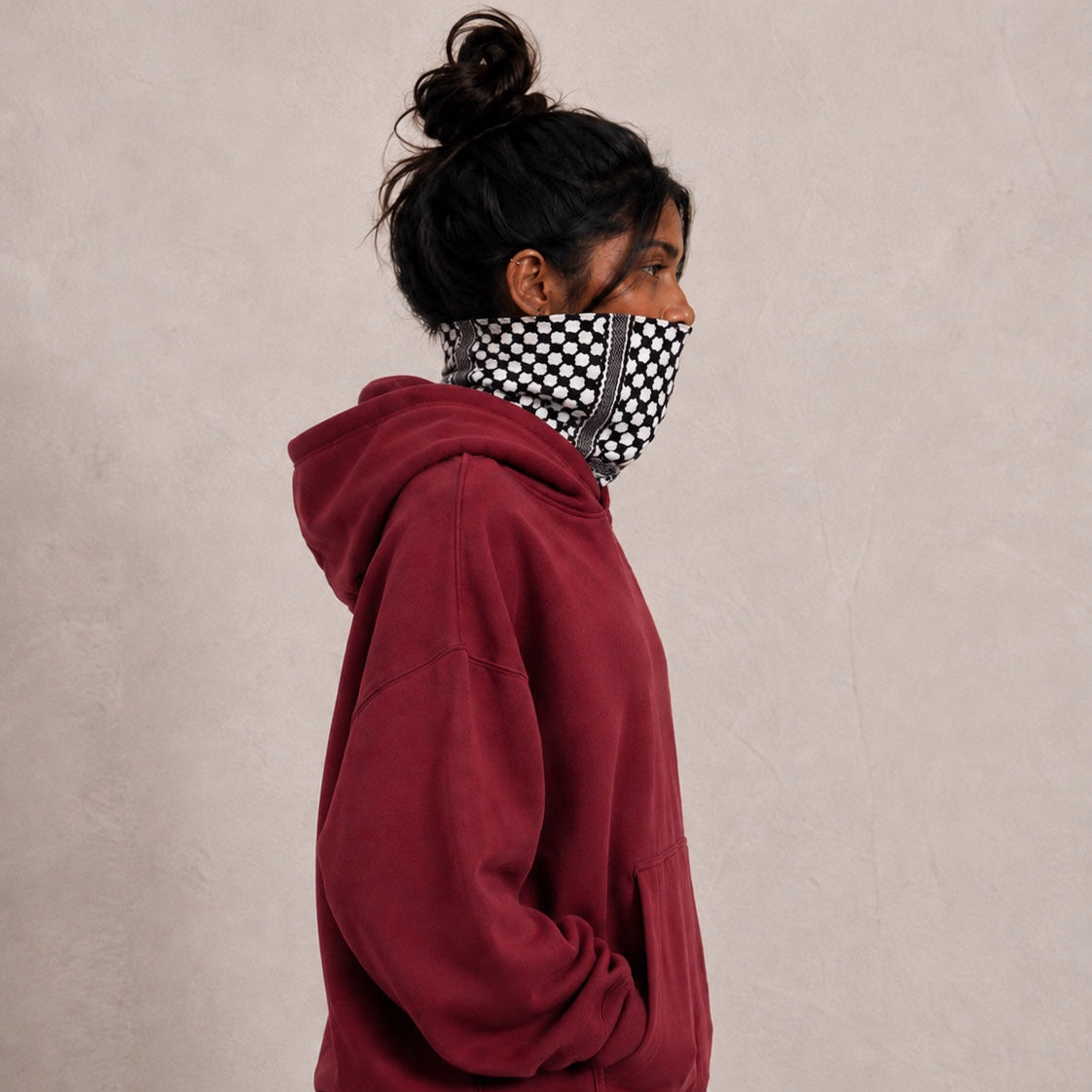 Side view of burgundy ANZ Privacy Hoodie showing built-in keffiyeh fabric mask